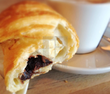 Load image into Gallery viewer, open chocolate croissant showing chocolate filling
